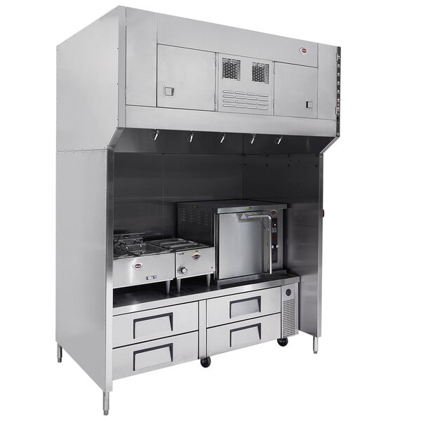 A stainless steel Wells ventless hood system over two ovens and a stove.