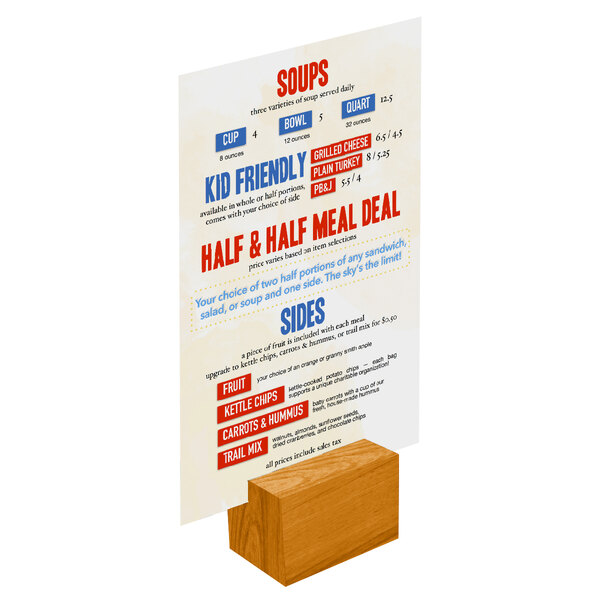 A Menu Solutions Country Oak wood rectangular card holder on a table holding a menu.