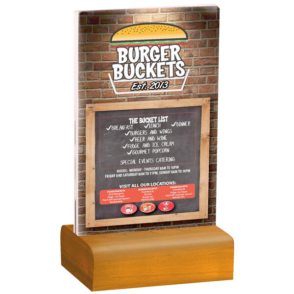 A Menu Solutions clear acrylic table tent with a solid country oak wood base on a table with a sign that says burger buckets.
