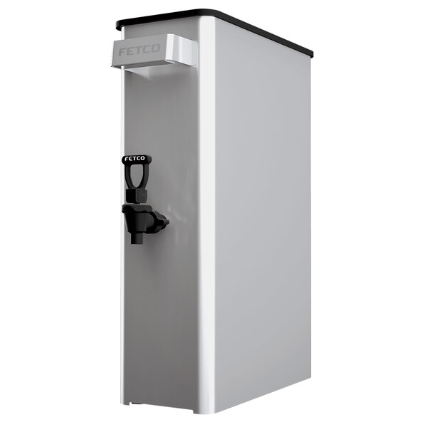 A stainless steel Fetco iced tea dispenser with a black lid and a black faucet.