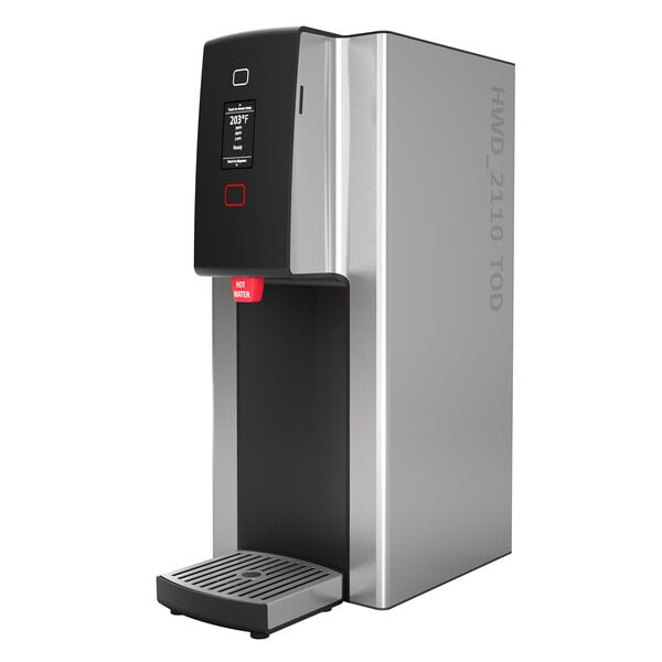 A silver and black Fetco hot water dispenser with black and red push-button controls.