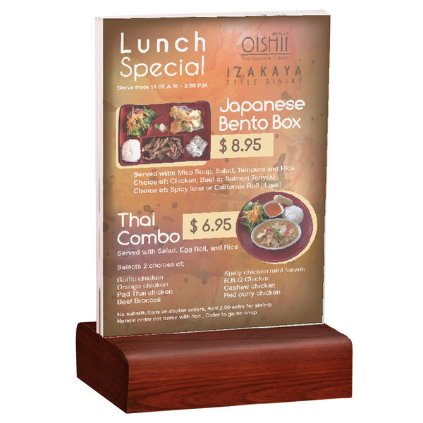 A Menu Solutions clear acrylic table tent with a solid mahogany wood base holding a menu on a table.