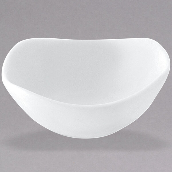 A white bowl with a curved edge on a white surface.