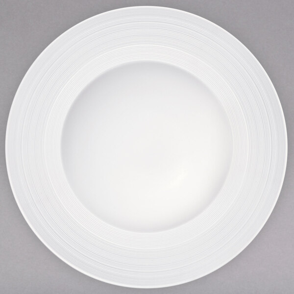 A white porcelain bowl with a white rim and circular pattern.