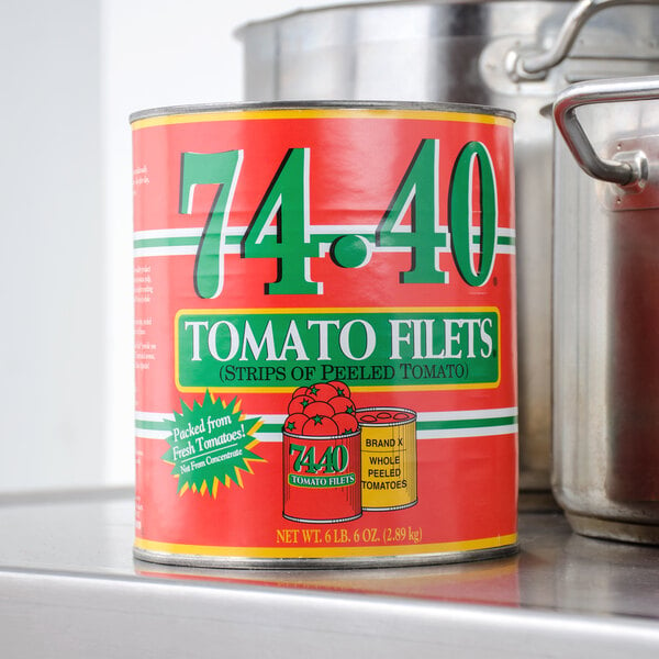 A Stanislaus #10 can of tomato filets on a counter.