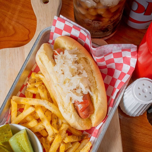 A tray with a Silver Floss sauerkraut-topped hot dog and fries.