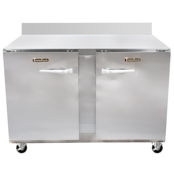 A large stainless steel Traulsen worktop refrigerator with two doors and two drawers.