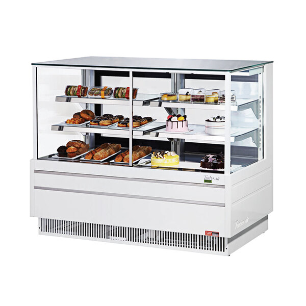 A white Turbo Air dual dry and refrigerated bakery display case with food on it.