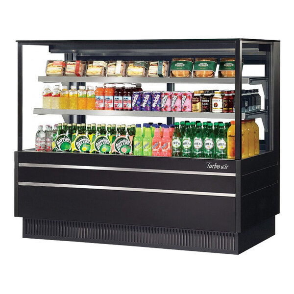 A Turbo Air white refrigerated bakery display case with drinks on shelves.