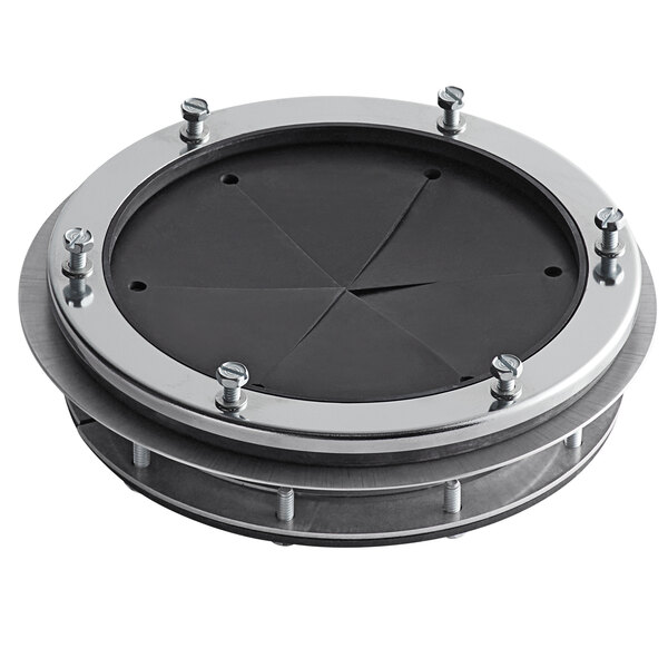 A black circular metal adapter with silver metal rims and four screws on it.