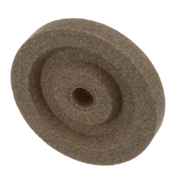 A brown Globe 7 Truing Stone wheel with a hole in the center.
