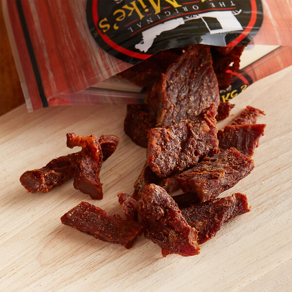 A bag of Uncle Mike's Original beef jerky on a table with a wooden surface.