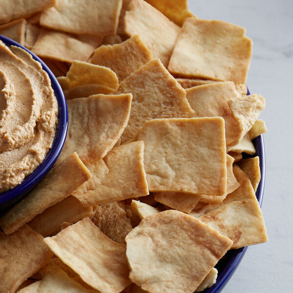 A bowl of Stacy's Simply Naked Pita Chips with a bowl of hummus.
