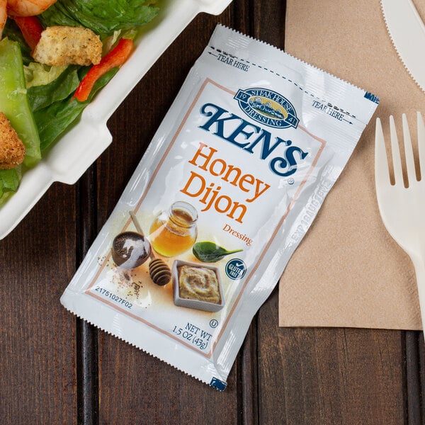 A salad with a Ken's Foods Honey Dijon Mustard dressing packet.