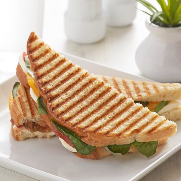 A grilled Wholesome Harvest White Panini sandwich on a plate.