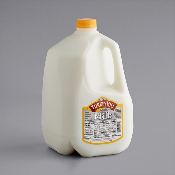 A Turkey Hill Fat Free Skim Milk jug with a label.