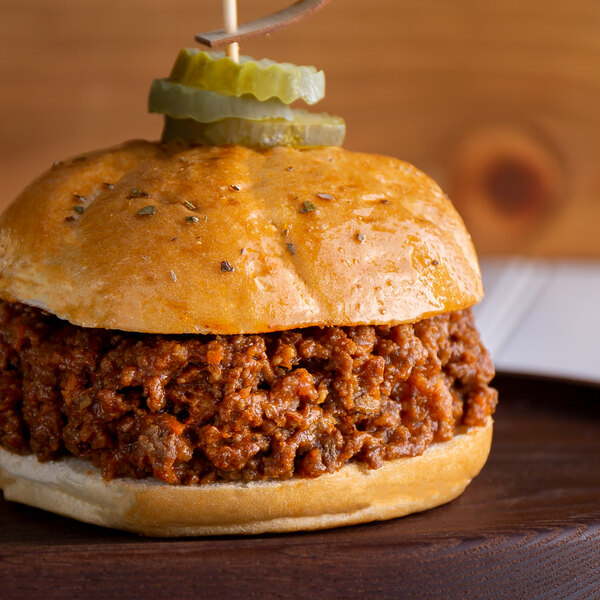 A sloppy beef BBQ sandwich on a plate.