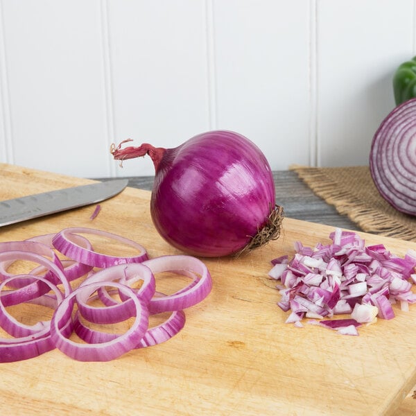 A Jumbo red onion sliced on a cutting board.