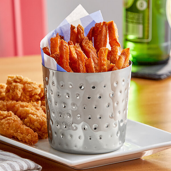 An Acopa stainless steel container filled with French fries and chicken wings.