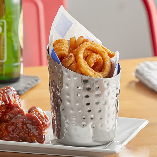 An Acopa stainless steel French fry holder filled with appetizers on a table.