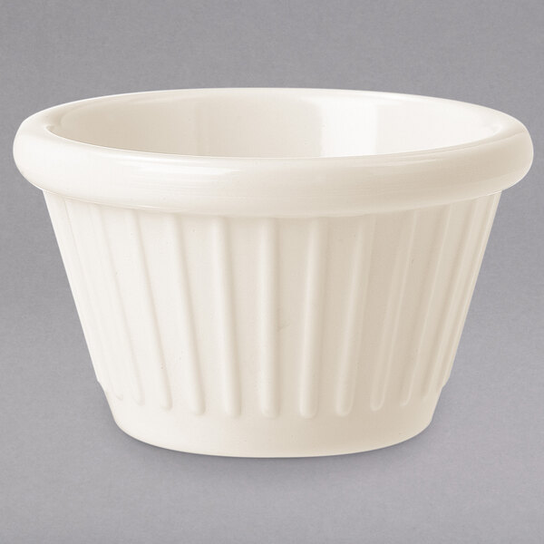 A ivory fluted ramekin with a ribbed pattern.
