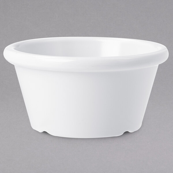 A white bowl on a grey surface.