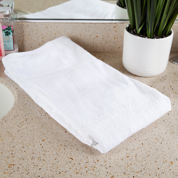 A white Oxford Belleeza bath towel on a counter.