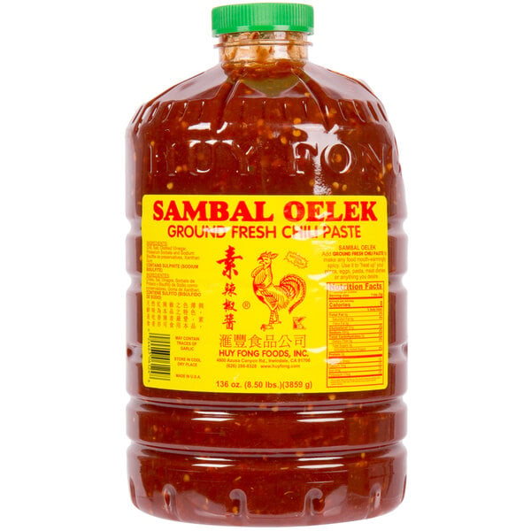 A large plastic container of Huy Fong Sambal Oelek chili paste with a label.