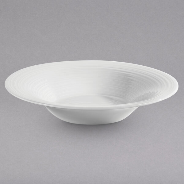 A white bowl with a white rim on a gray surface.