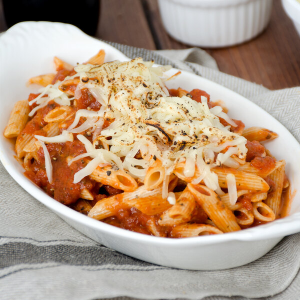 A white bowl of Napoli Penne Rigate pasta with sauce and cheese.