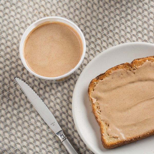 A piece of toast with Downey's Cinnamon Honey Butter spread on a plate.