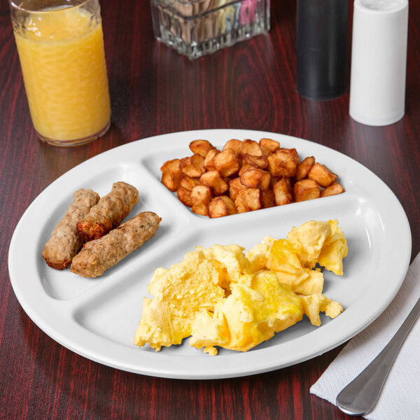 A Carlisle white melamine 3-compartment plate with breakfast food on it.