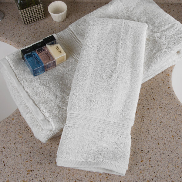 A group of white Oxford Vicenza hand towels on a counter.