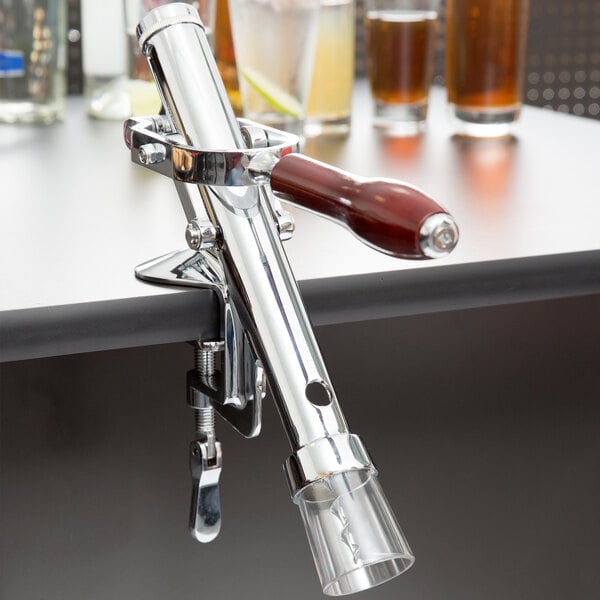 A Thunder Group table mount wine bottle opener on a metal bar.