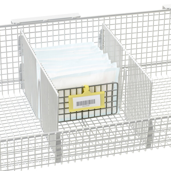 A Metro wire basket divider with a yellow tag and barcode.