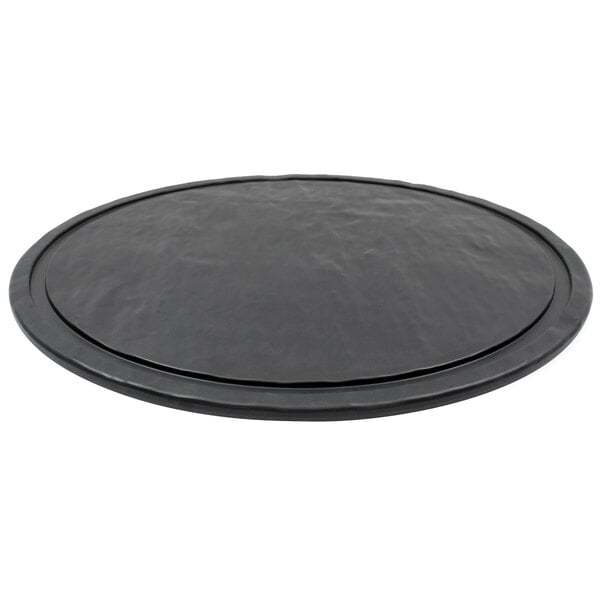 A Tablecraft Frostone round faux slate melamine display tray with a black rim.