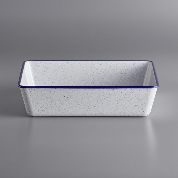 A white rectangular melamine serving bowl with blue speckles.