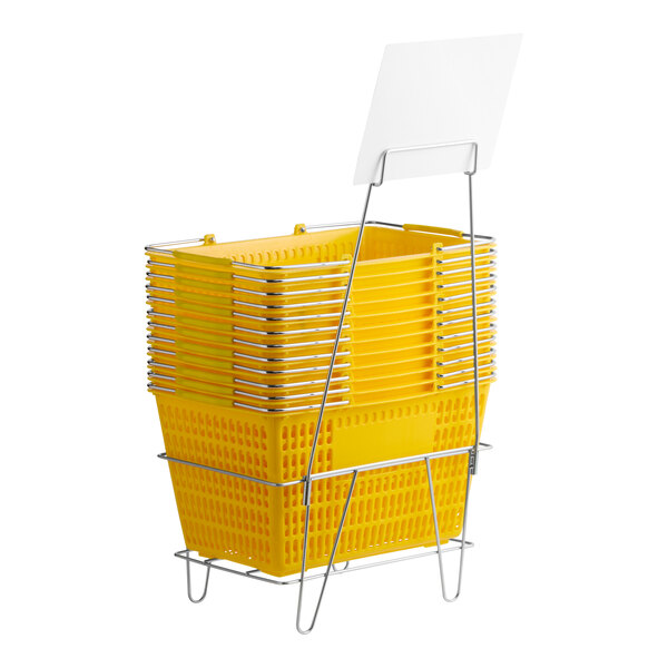 A set of yellow plastic grocery market shopping baskets stacked on a metal stand with an attached sign holder.