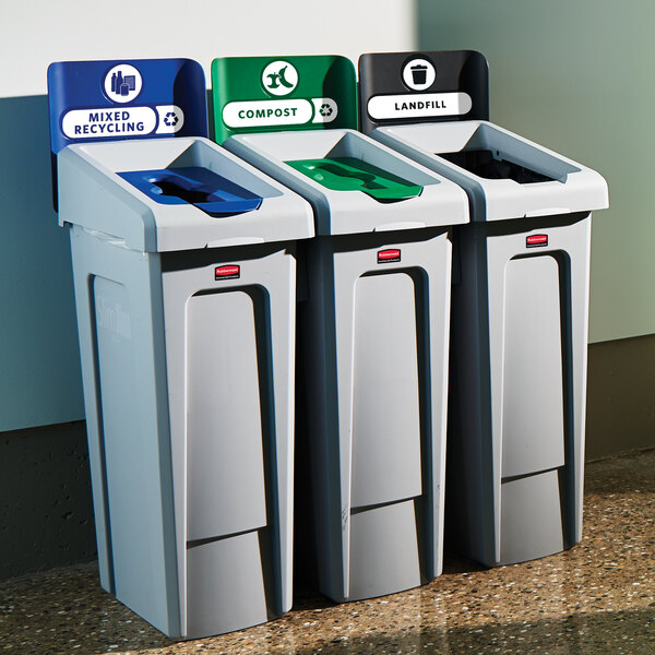 A white rectangular Rubbermaid Slim Jim recycling station with three recycle bins and lids.