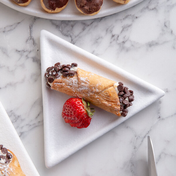 A G.E.T. Enterprises white triangle buffet platter with pastries and a strawberry.