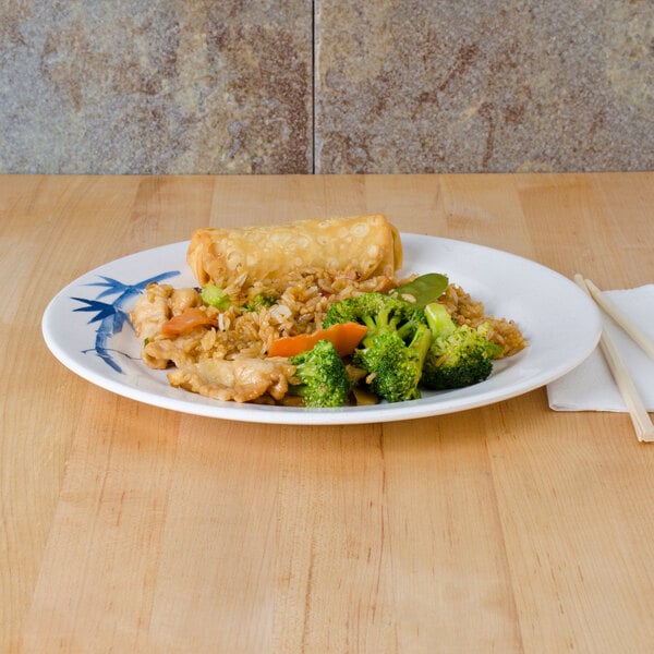 A Thunder Group Blue Bamboo melamine plate with broccoli, rice, and chopsticks on a table.
