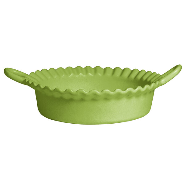 A lime green G.E.T. Enterprises Bugambilia deep Mexican cazuela bowl with handles and a wavy edge.
