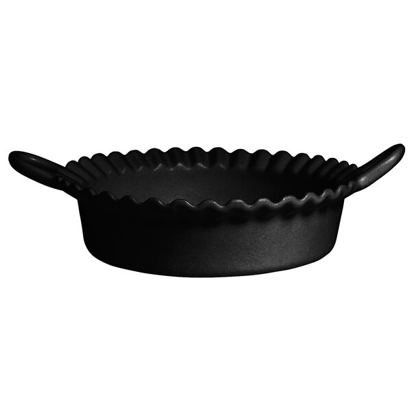 A black round G.E.T. Enterprises Bugambilia deep Mexican cazuela pan with handles.