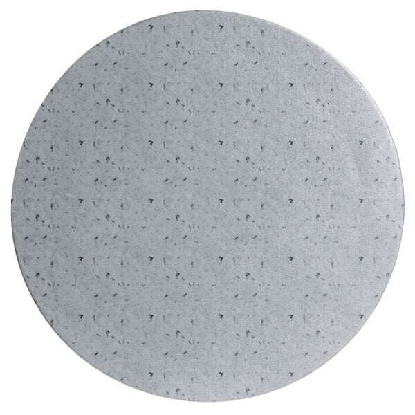 A white round metal disc with black specks.