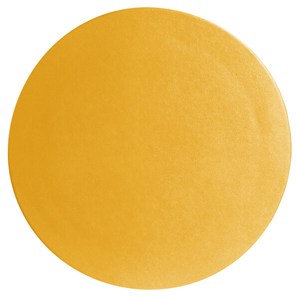 A close-up of a yellow surface with a textured finish in a circular shape.