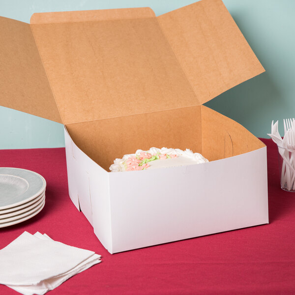 A white cake in a 12" x 12" x 6" white bakery box.