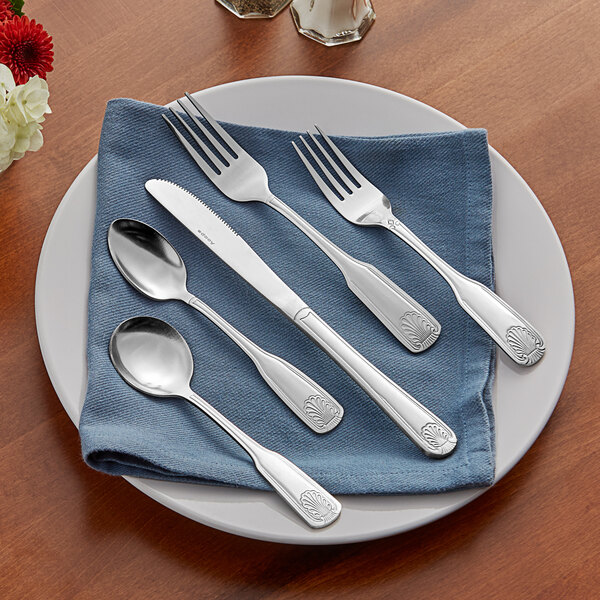 Acopa Atglen stainless steel flatware on a blue napkin.