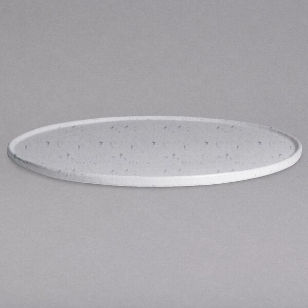 A close-up of a G.E.T. Enterprises marble white granite resin-coated aluminum round tray with a rim and holes on a white background.