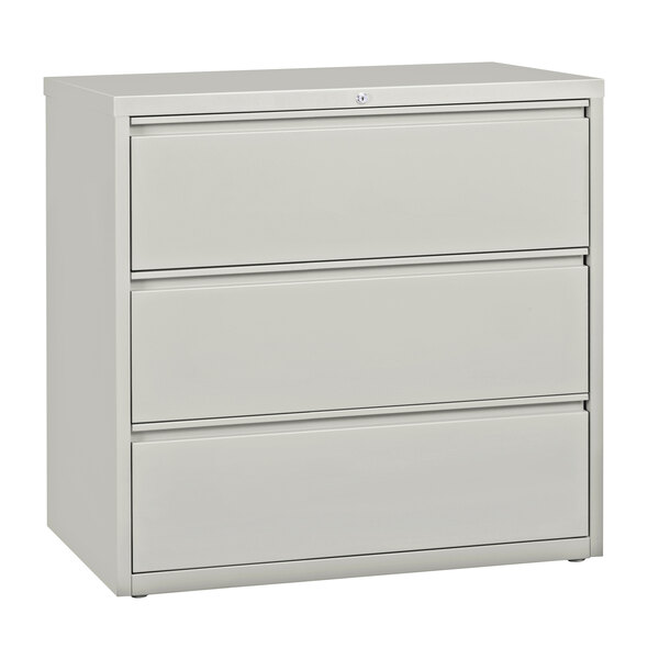A gray filing cabinet with three drawers.