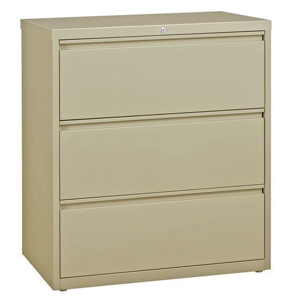 A tan Hirsh Industries three-drawer lateral file cabinet.